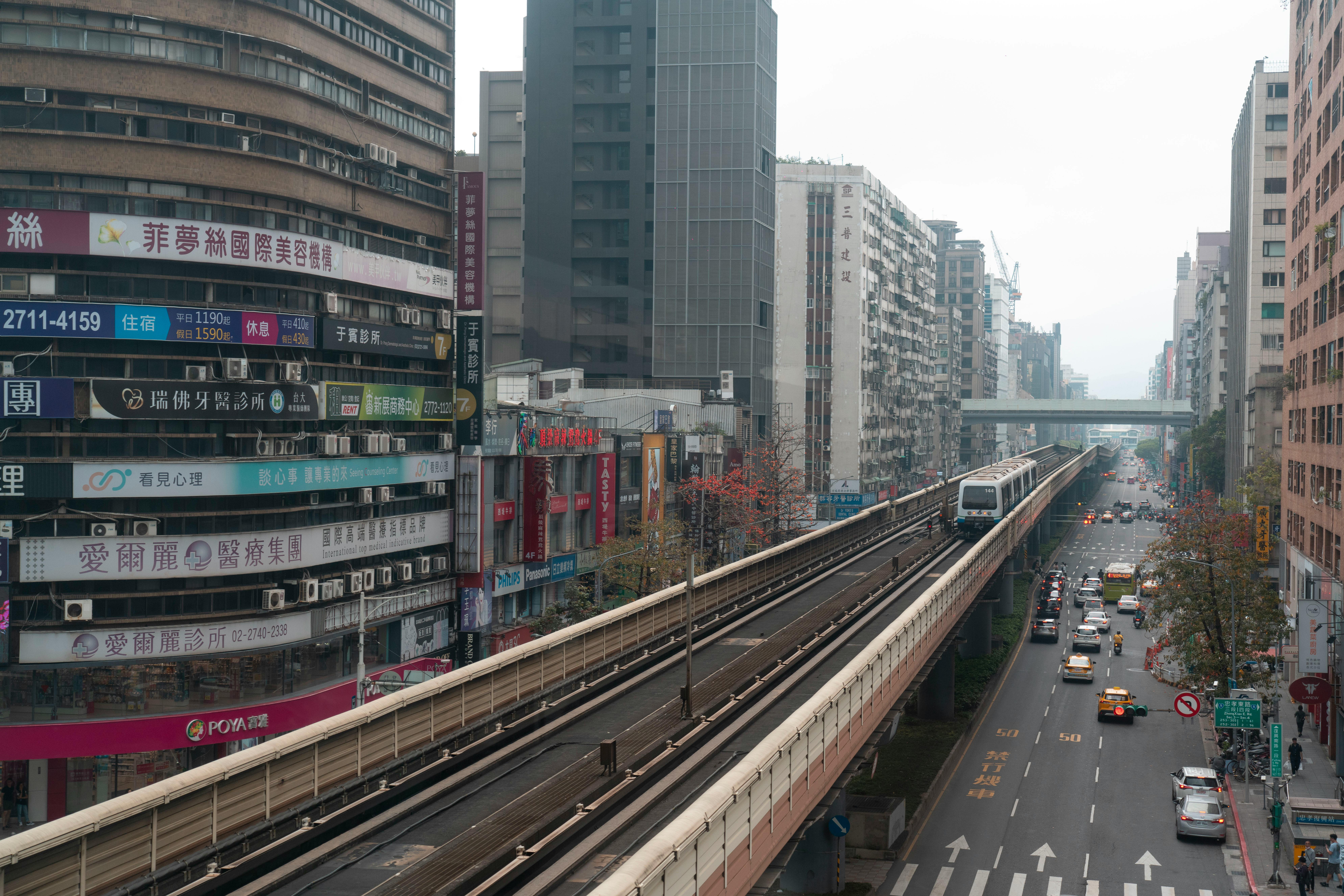 High angle view of Taipei's urban landscape featuring elevated train and busy streets