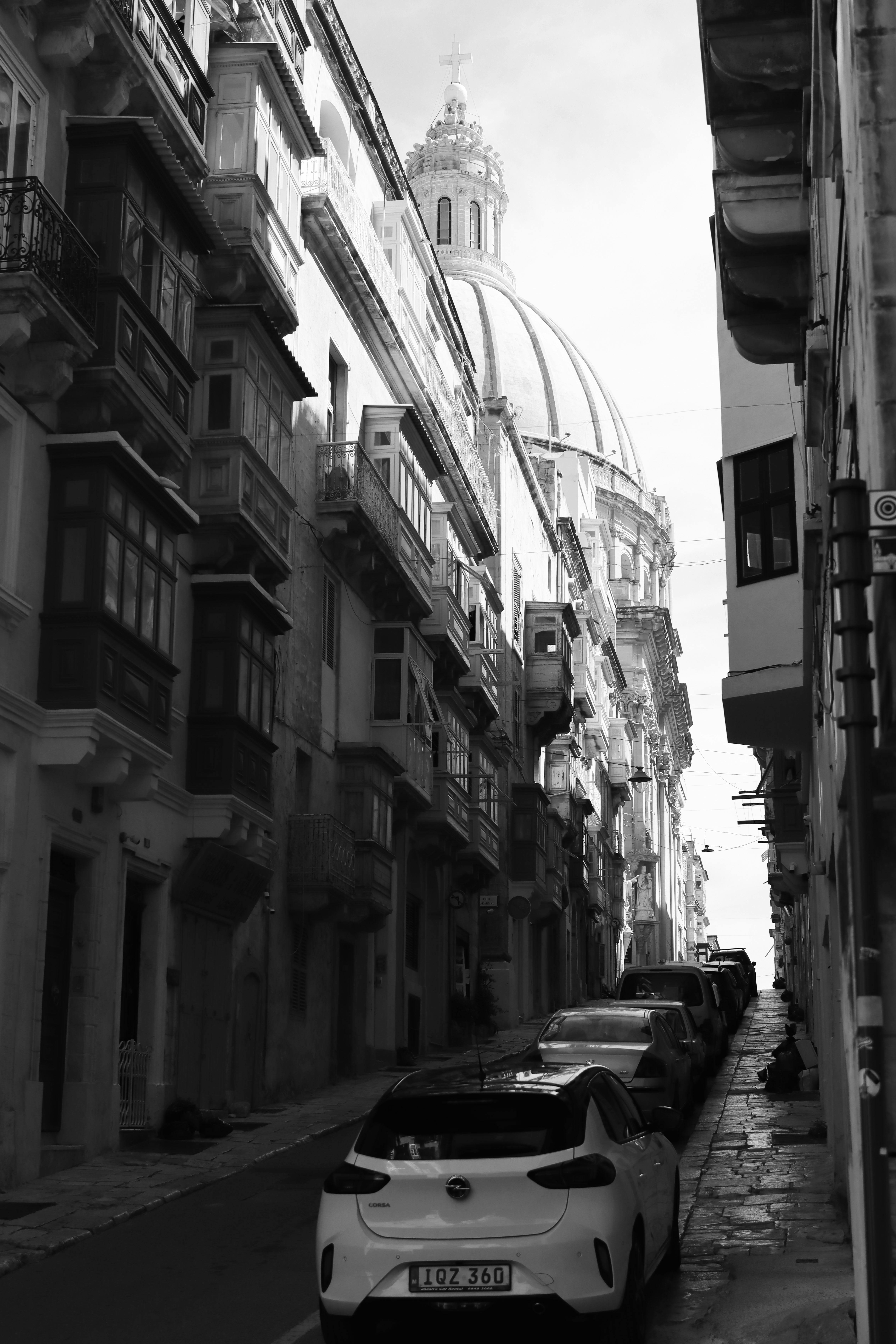 Explore the narrow, historic streets of Valletta, Malta with its iconic dome and classic architecture.