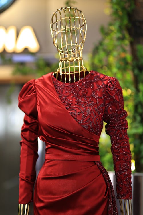 A mannequin dressed in red is displayed in a store