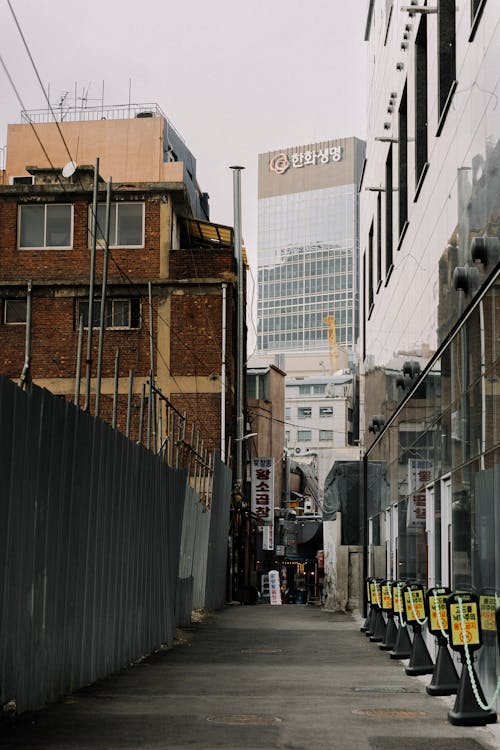 A city street with parking meters and buildings