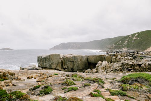 A rocky shoreline with a large rock formation