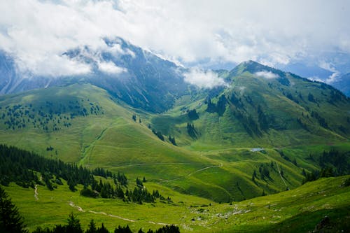 A mountain landscape with green grass and mountains