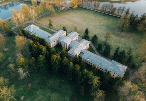 Aerial view of a large building surrounded by trees