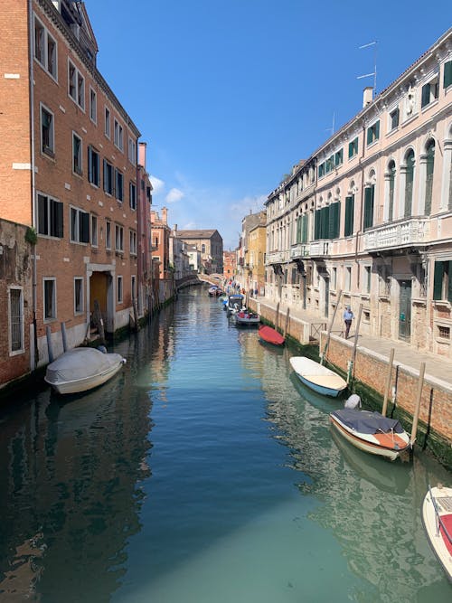 A canal in venice with boats and buildings