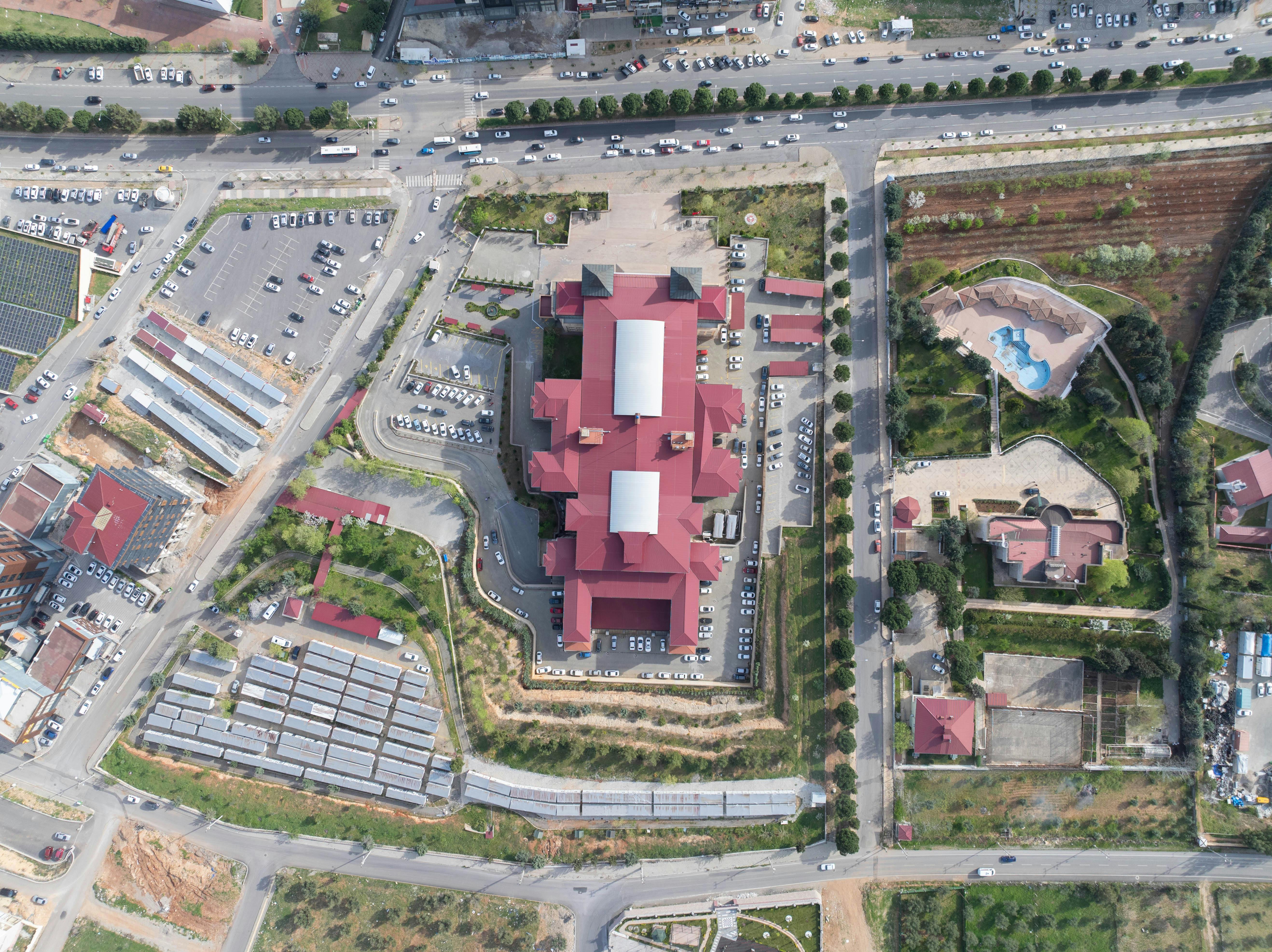 Aerial view of Loveworld Arena near Glory Gas Road in Ghana showing modern church architecture with a vibrant parking lot