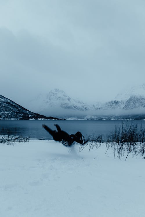 A person is flying through the air in the snow
