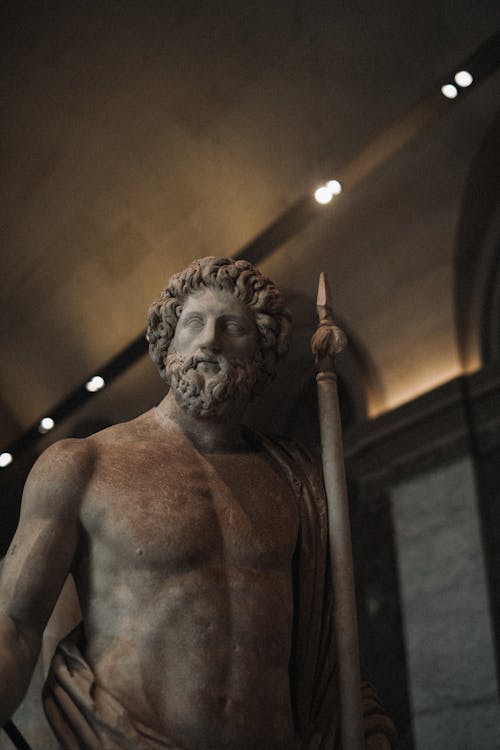 A statue of a man with a beard and a spear