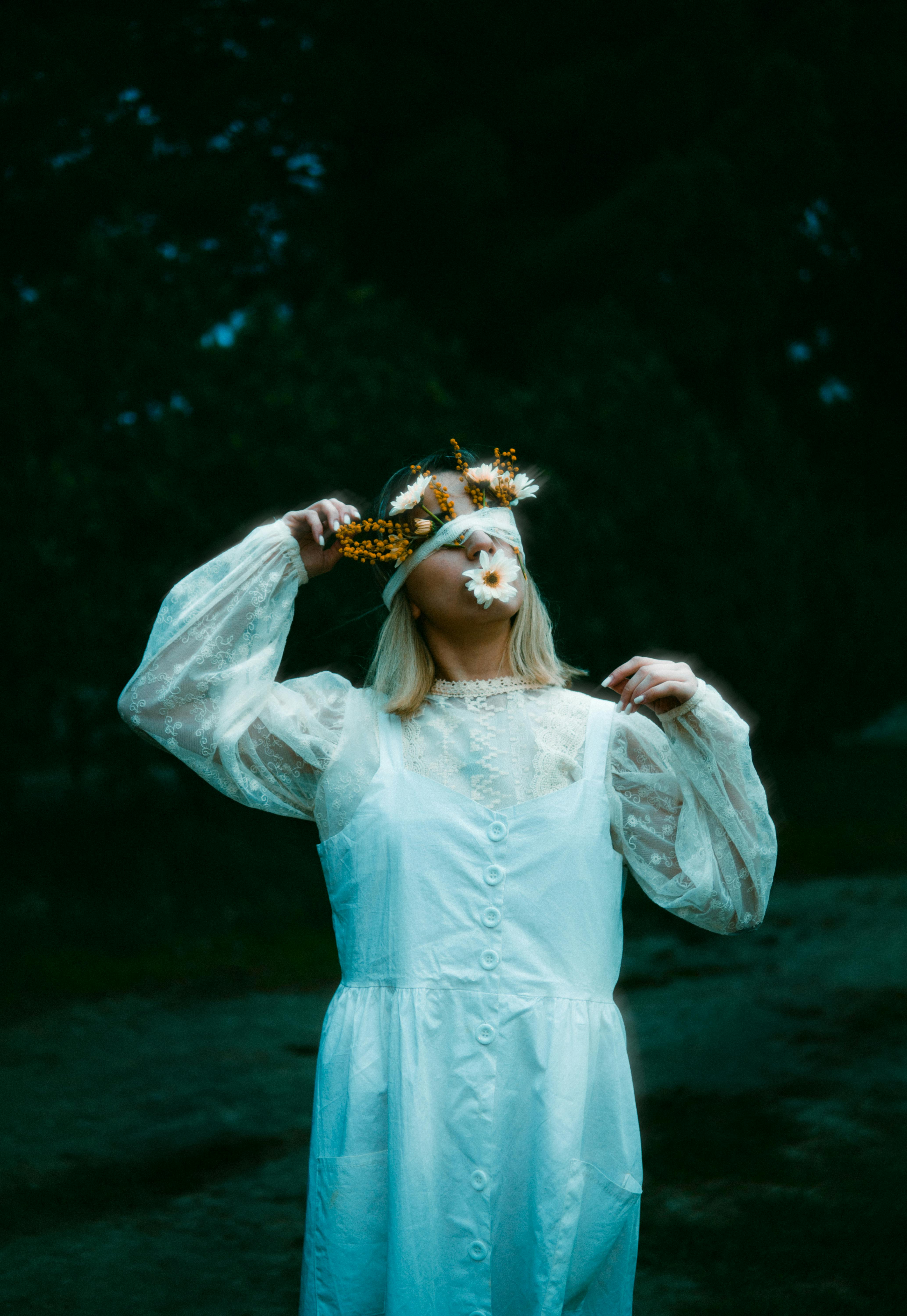 blonde woman with flowers under blindfold