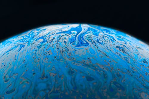 A close up of a blue planet with swirls
