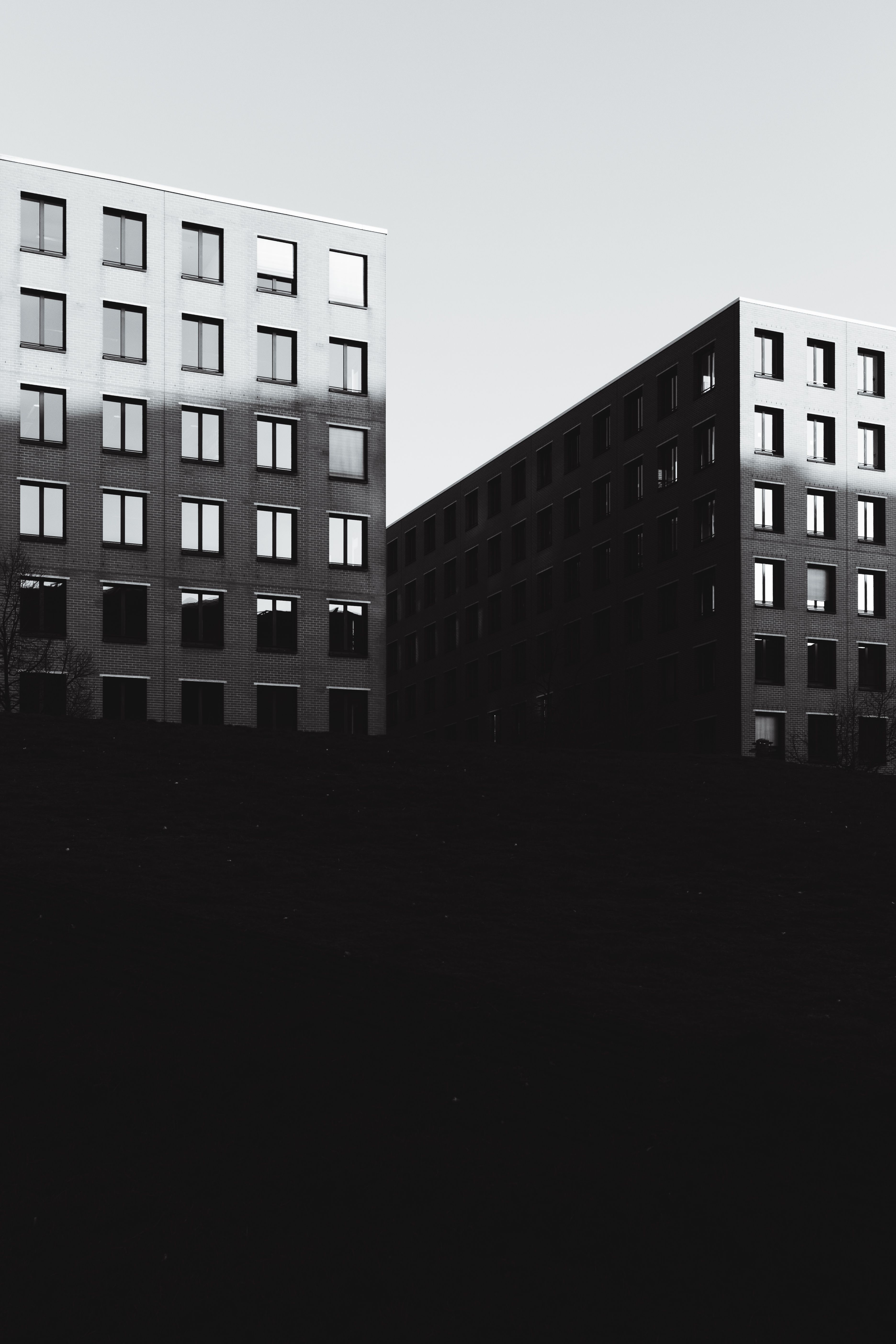 Black and white photo showcasing modern building facades in Berlin. Ideal for backgrounds or architectural studies.