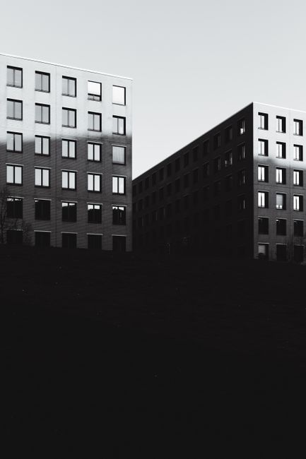 Black and white photo showcasing modern building facades in Berlin. Ideal for backgrounds or architectural studies.