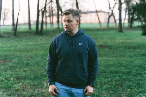 A man in a hoodie standing in a field