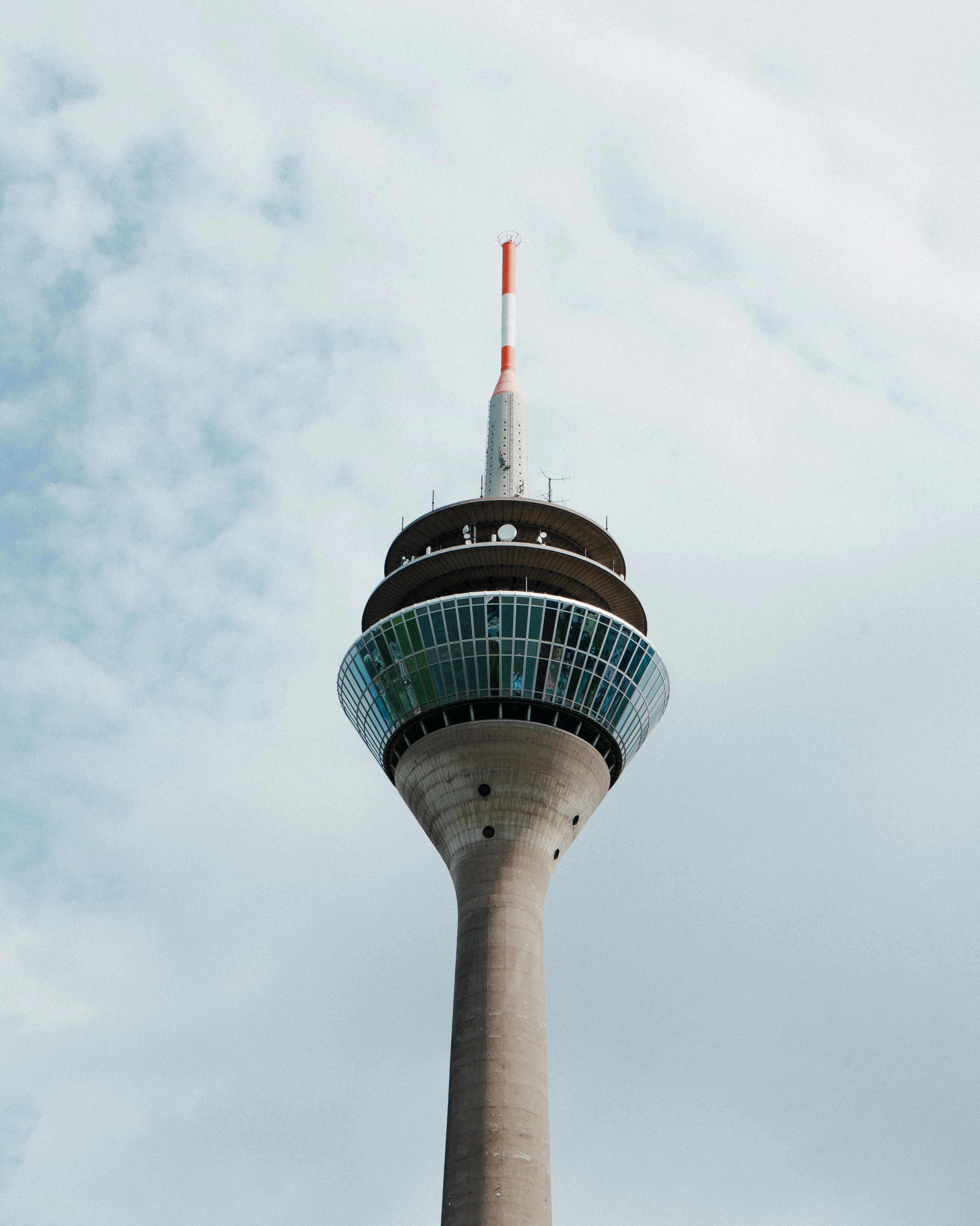 Modern architecture of Rhine Tower in Düsseldorf, Germany set against a cloudy sky.