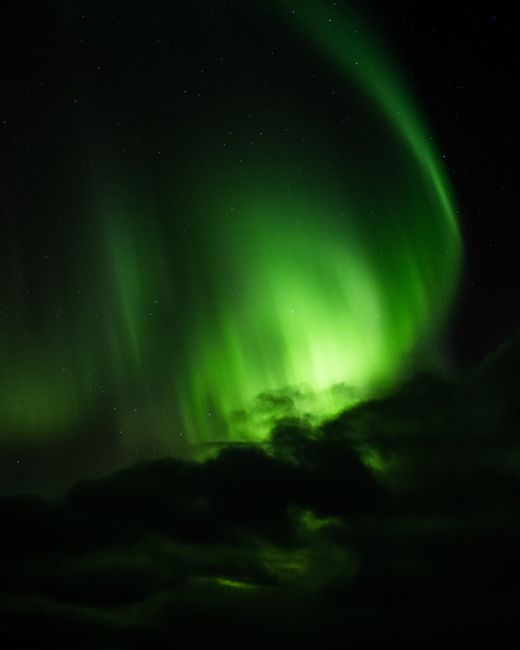 Stunning aurora borealis over Reykjavík's night sky, a breathtaking natural wonder.