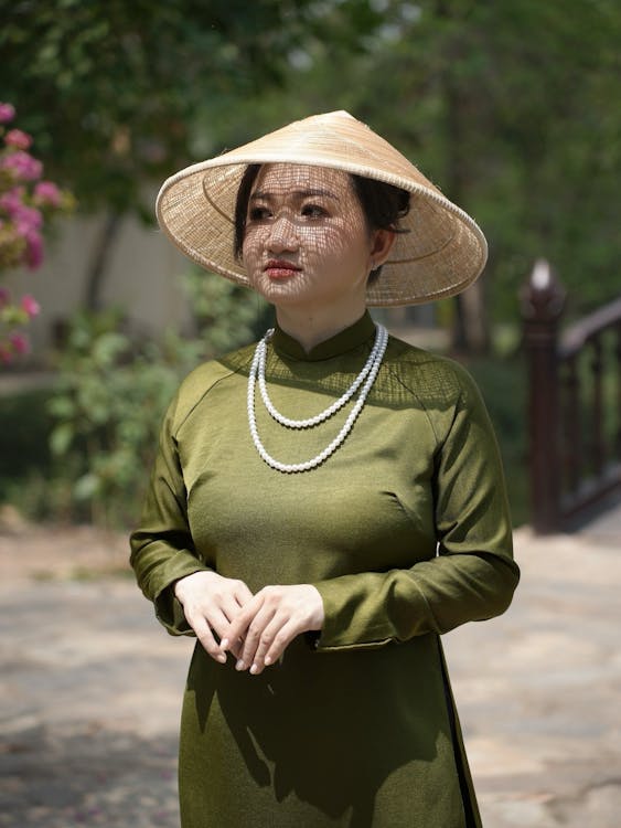 A woman in a green dress and hat