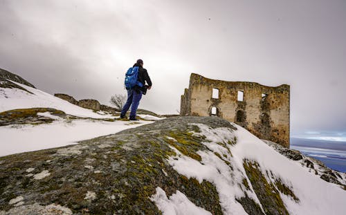 Person Hiking to a Stone Wall