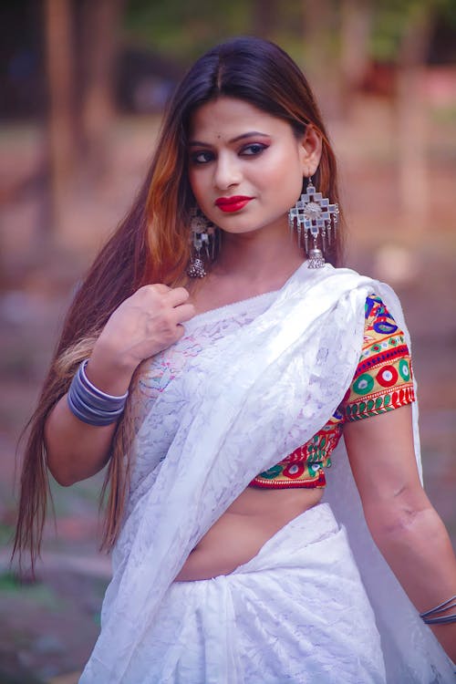 A beautiful indian woman in a white sari