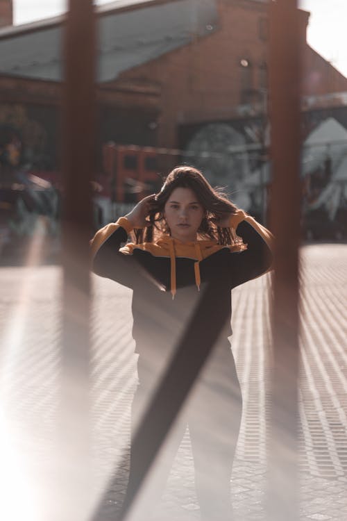 Shallow Focus Photo of Woman in Black and Yellow Pullover Hoodie