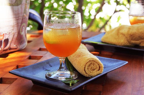 Short-stemmed Clear Wine Glass Filled With Orange Liquid