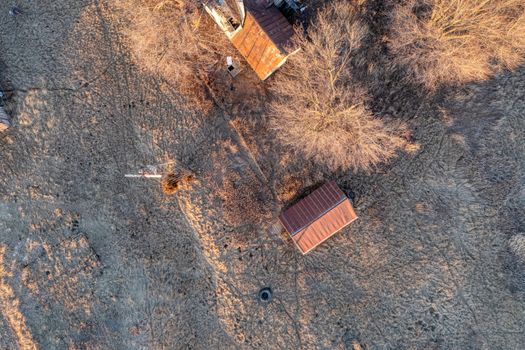Winter aerial view of rural farm buildings with bare trees in Minnesota.