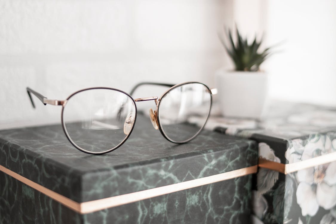 Free Gray-framed Eyeglasses on Black Surface Stock Photo
