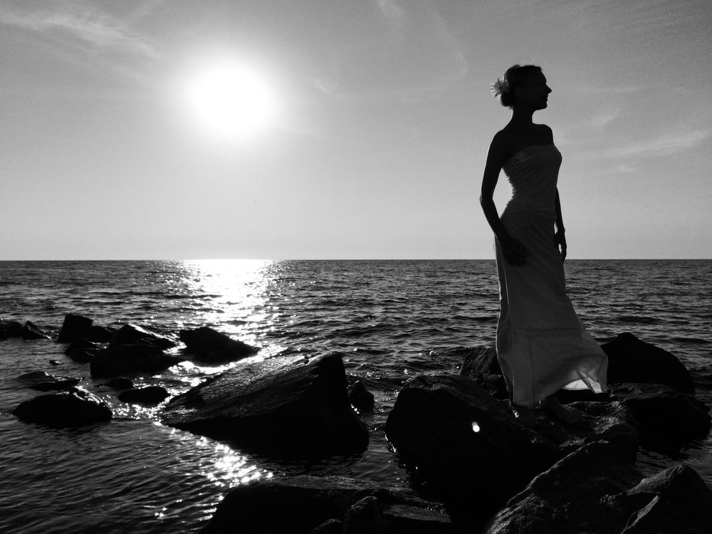 Beautiful silhouette of a girl in the sea · Free Stock Photo
