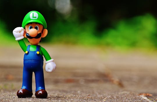 Close-up of a Luigi figurine from a videogame standing on outdoor pavement, showcasing fun and play.