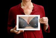 Woman Holding White Tablet Computer Showing Gray Bra