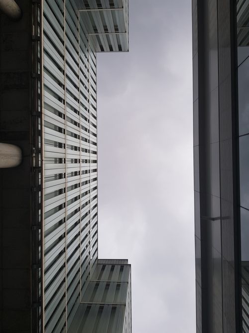 Free Dynamic low angle view of modern skyscrapers with a symmetrical composition. Stock Photo