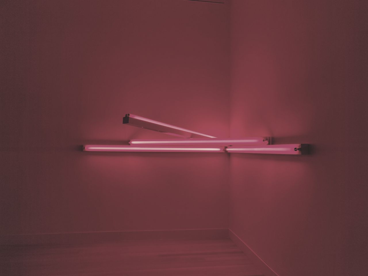 close up of abstract pink fluorescent light tubes against a dark backg