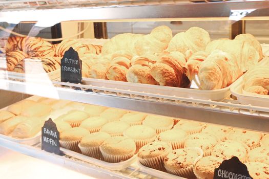 A tempting display of croissants and muffins fresh from the bakery, ready to enjoy.
