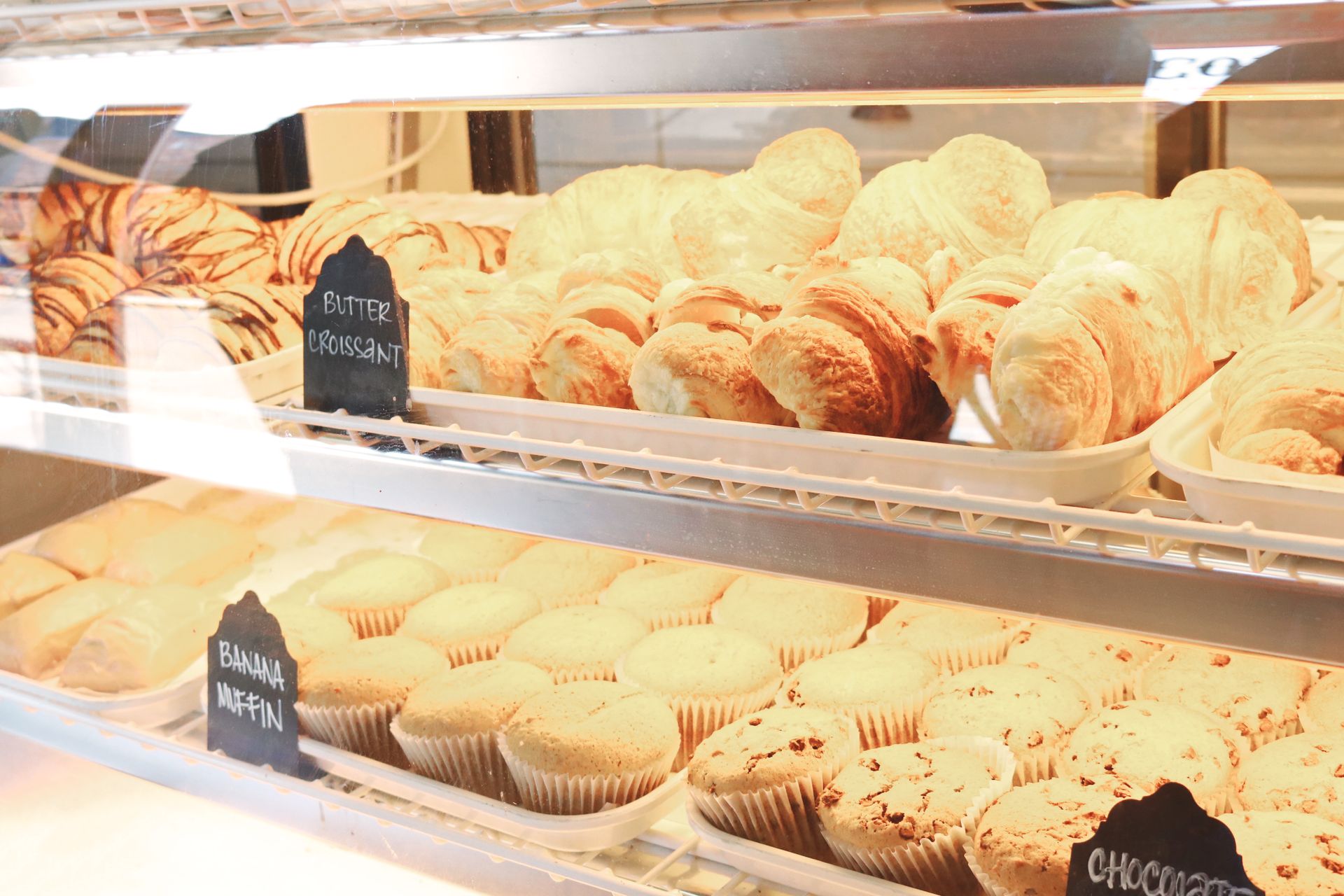 Croissants and Muffins Displayed at a Bakery