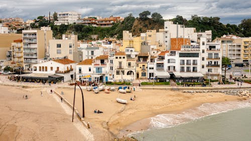 A beach with buildings and people on it