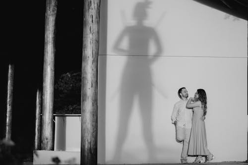 Embracing Couple by a Wall with a Large Shadow
