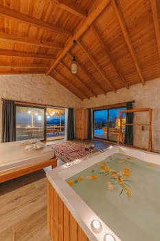 Elegant villa bedroom featuring a modern jacuzzi and wooden ceiling, creating a luxurious and cozy atmosphere.