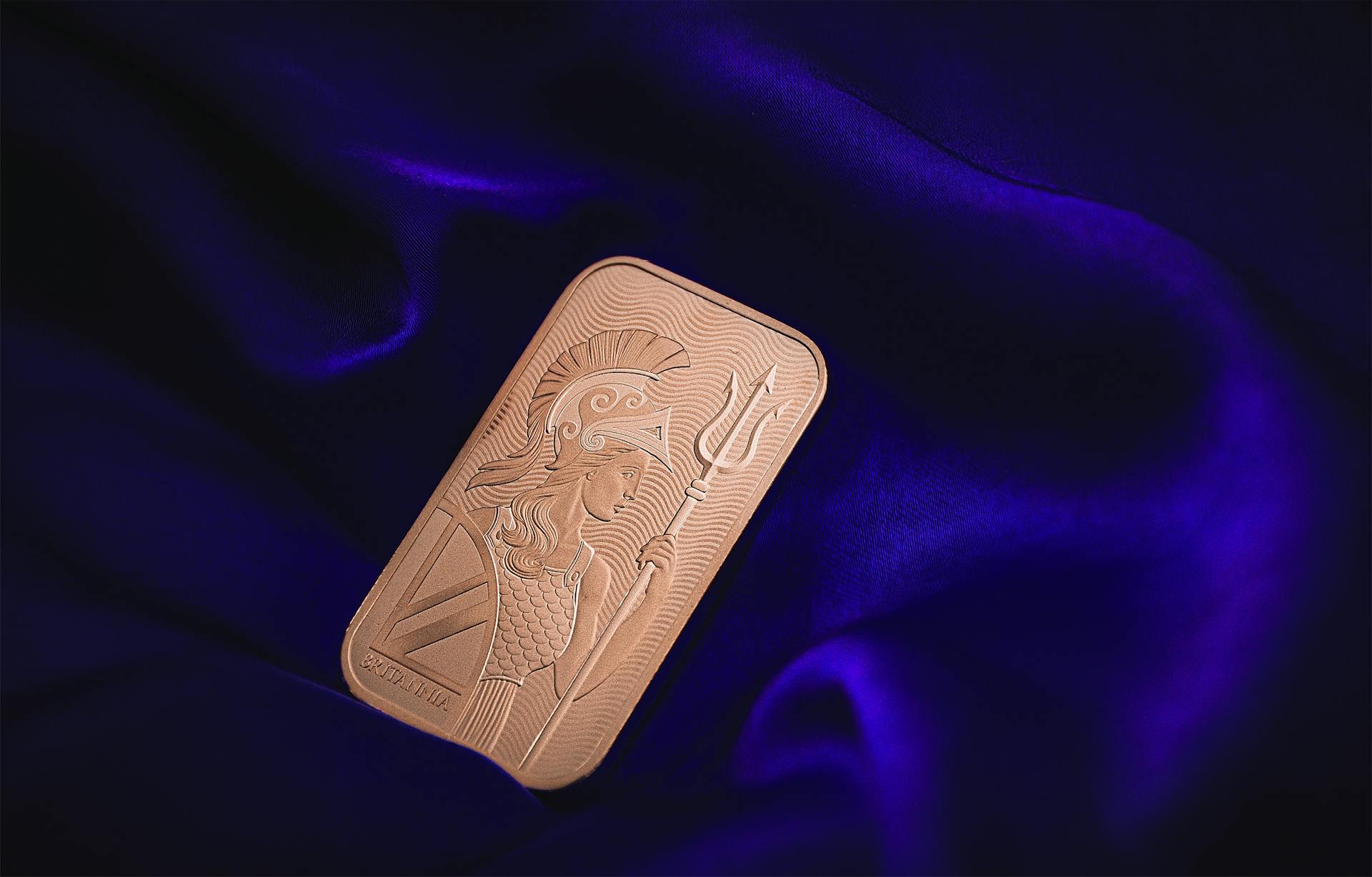 Close-up of a gold bar on rich purple fabric, symbolizing wealth and luxury.