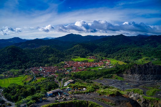 A stunning aerial view of Cigudeg village amidst lush green hills and mountains in West Java, Indonesia.