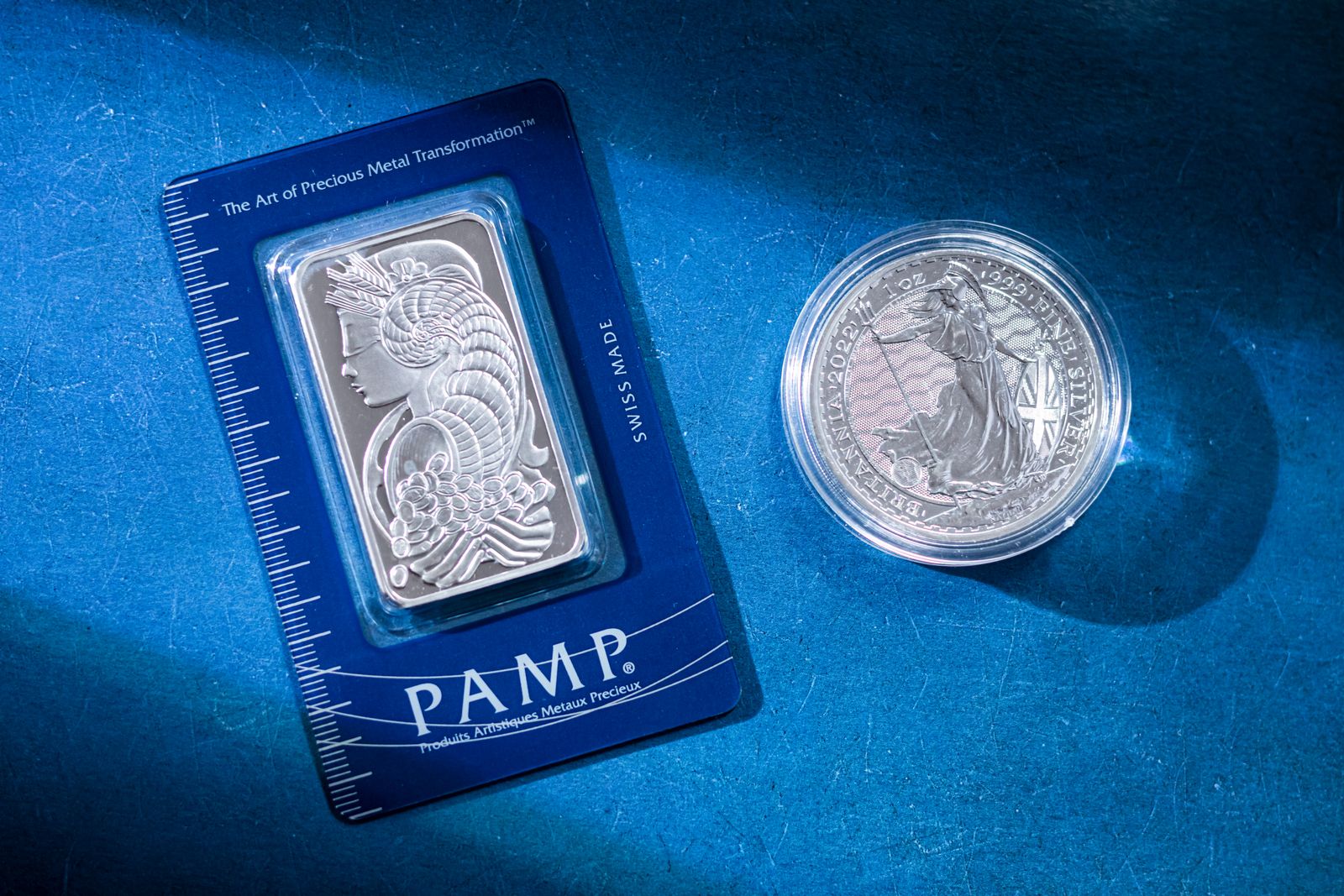 A silver bar and a silver coin