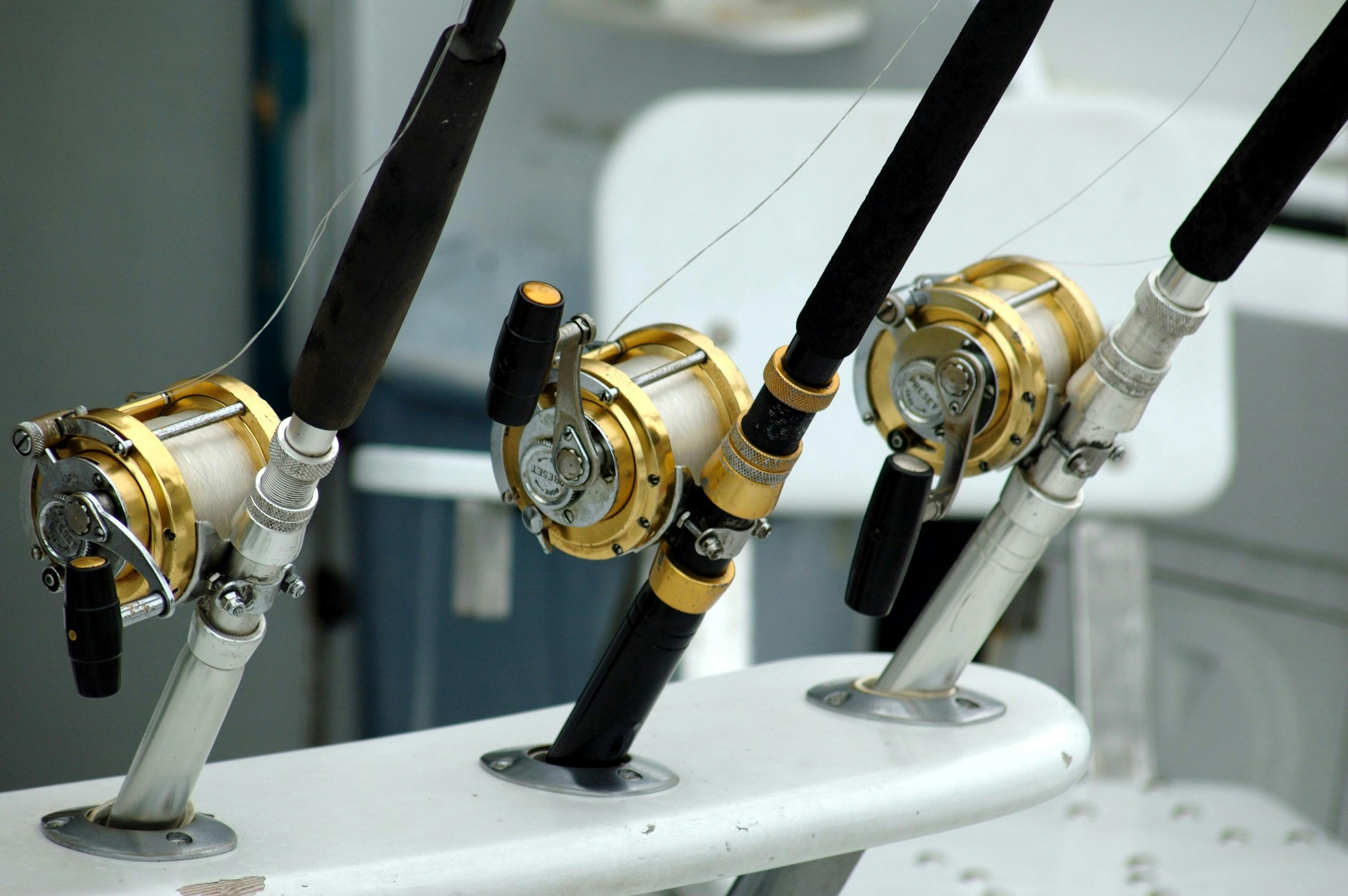 3 Lined Brass and Black Fishing Reel · Free Stock Photo
