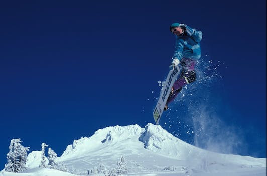 Man Snowboarding during Daytime