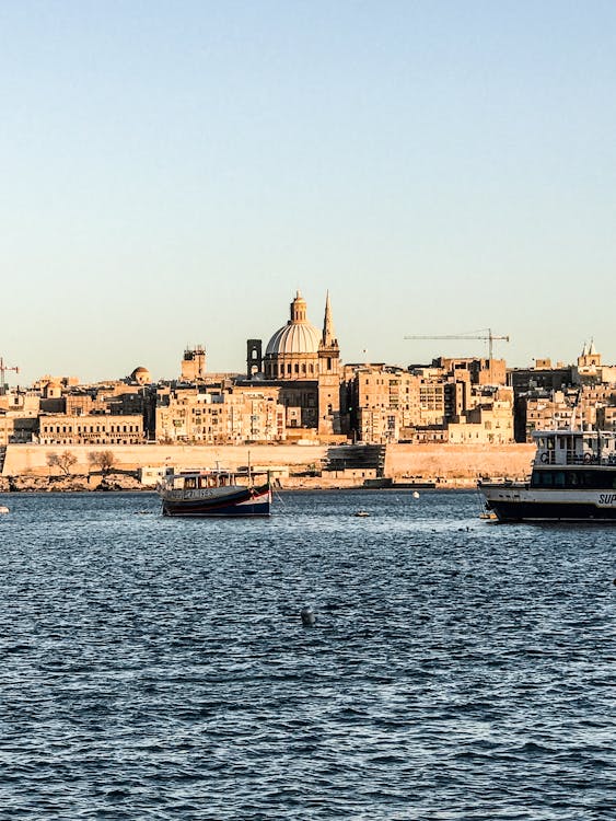 Two Ship on Body of Water Near Buildings