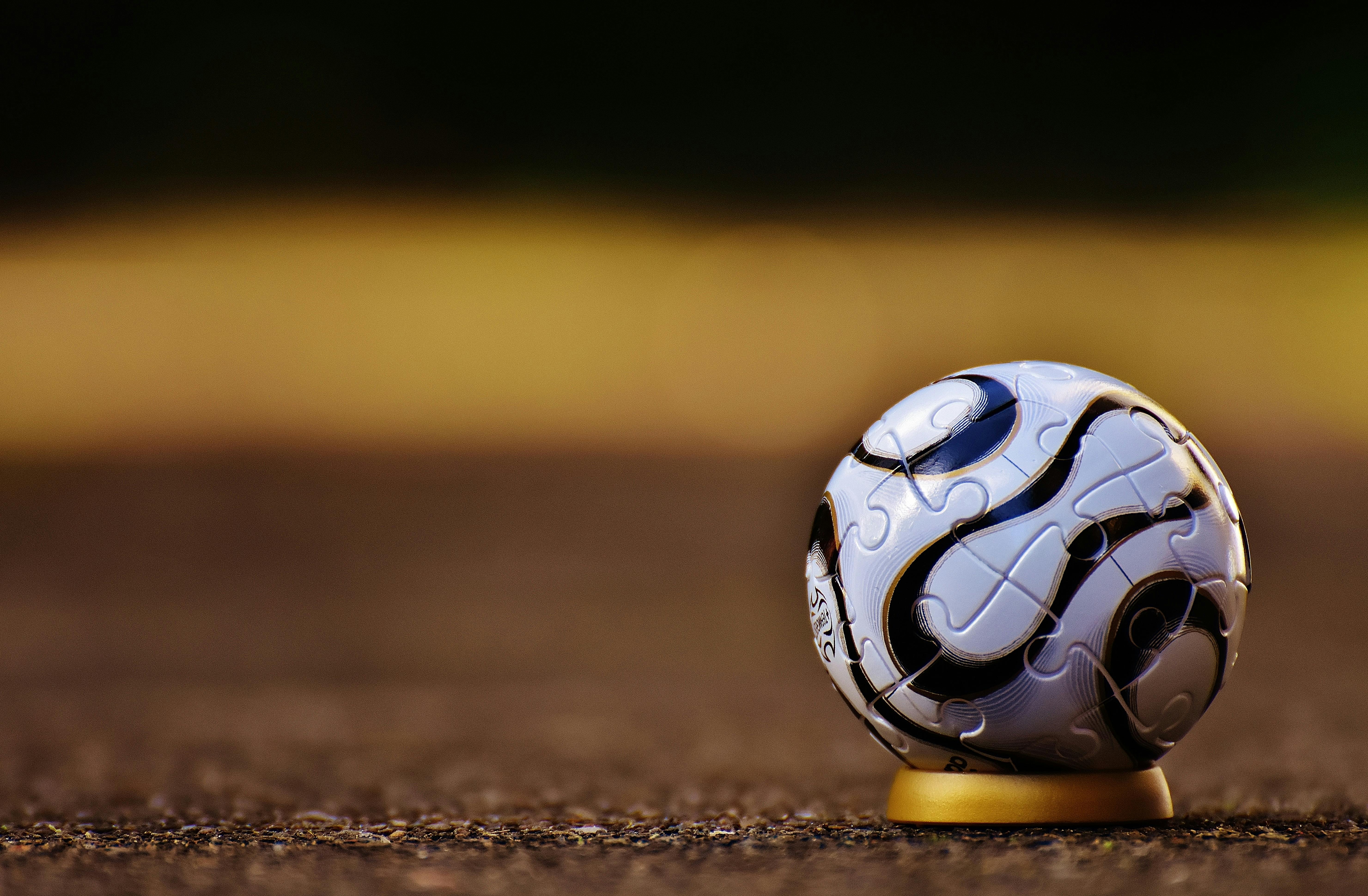 Wallpaper Orange and Black Soccer Ball on Green Grass, Background -  Download Free Image