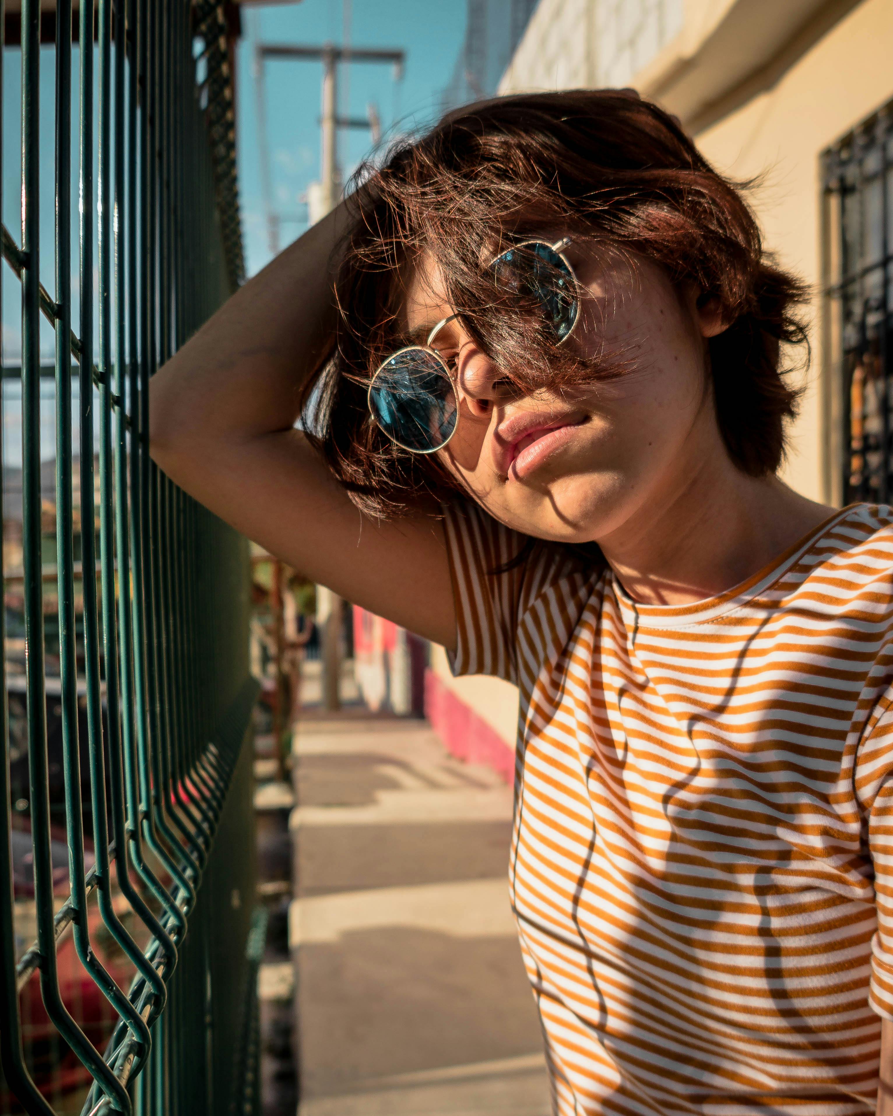 Woman Wearing Stripe T-shirt Standing Near Railings · Free Stock Photo