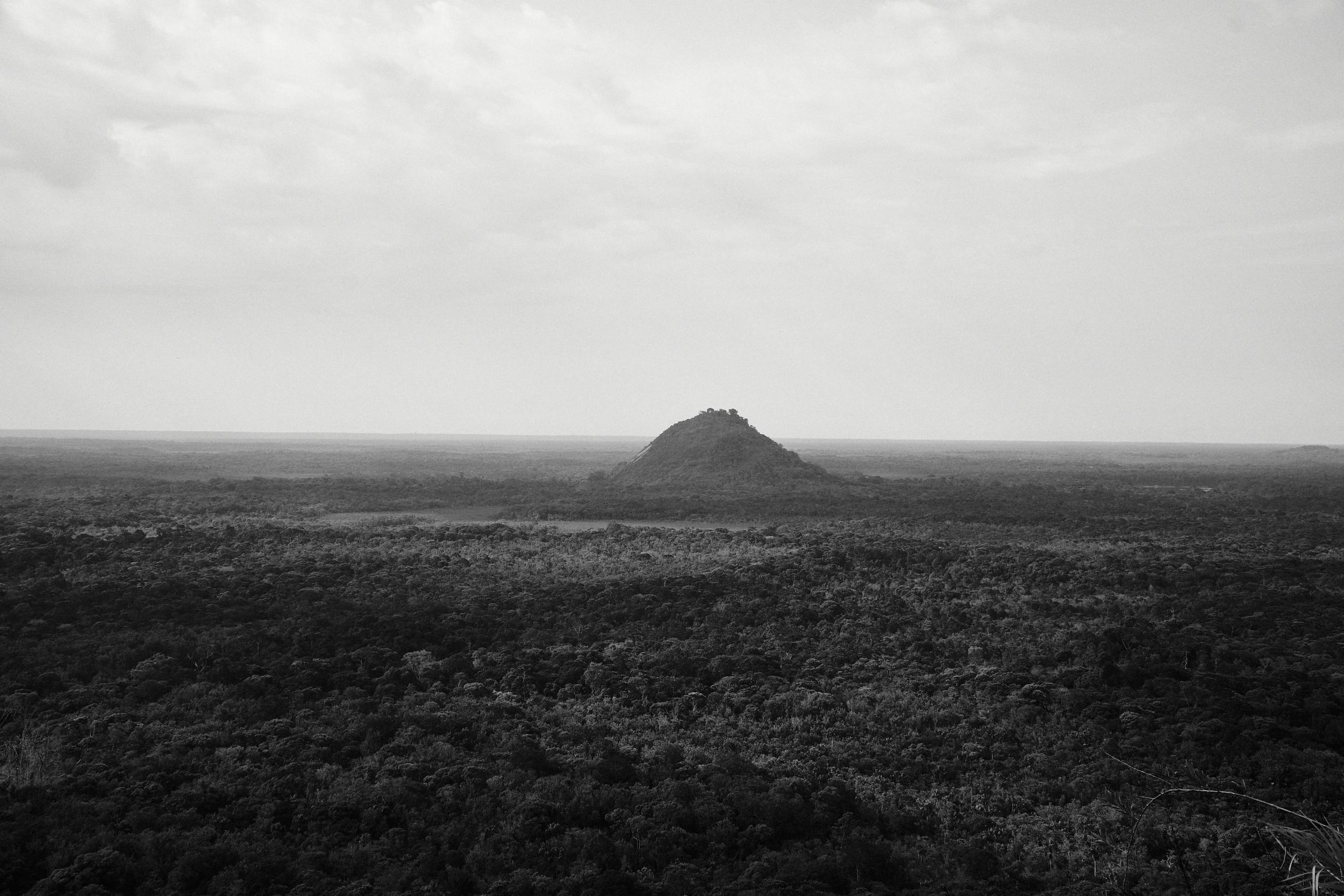 A stunning black and white aerial view of a mountain amidst lush forests in Inírida, Colombia.