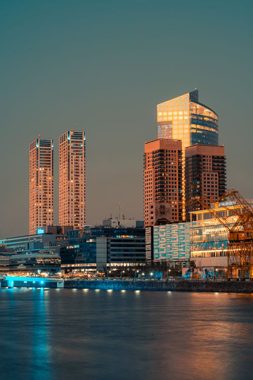 Free Stunning Buenos Aires skyline at dusk with illuminated skyscrapers and reflections on the river. Stock Photo
