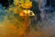 一座象征成就和成功的金色小雕像，笼罩在充满活力的黄蓝烟雾中