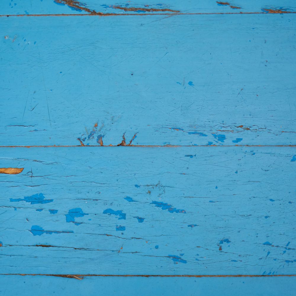 Fence and Decking Painting in Stepney — a decorator at work mid-project