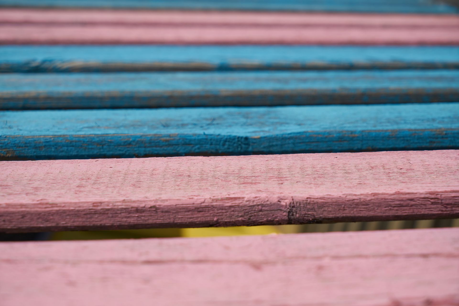 Close-up of pink and blue wooden planks creating a colorful pattern.