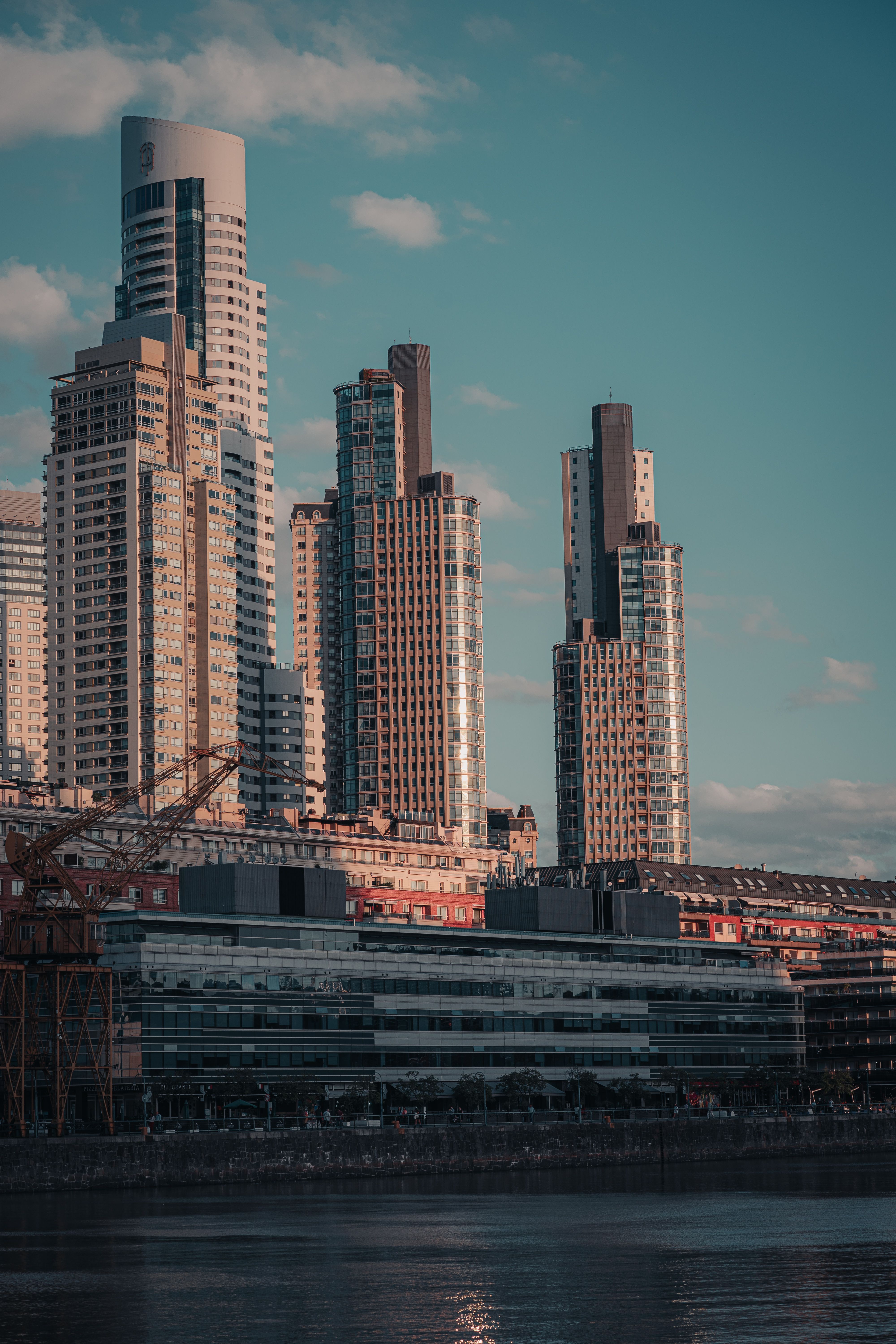 A city skyline with tall buildings and water · Free Stock Photo