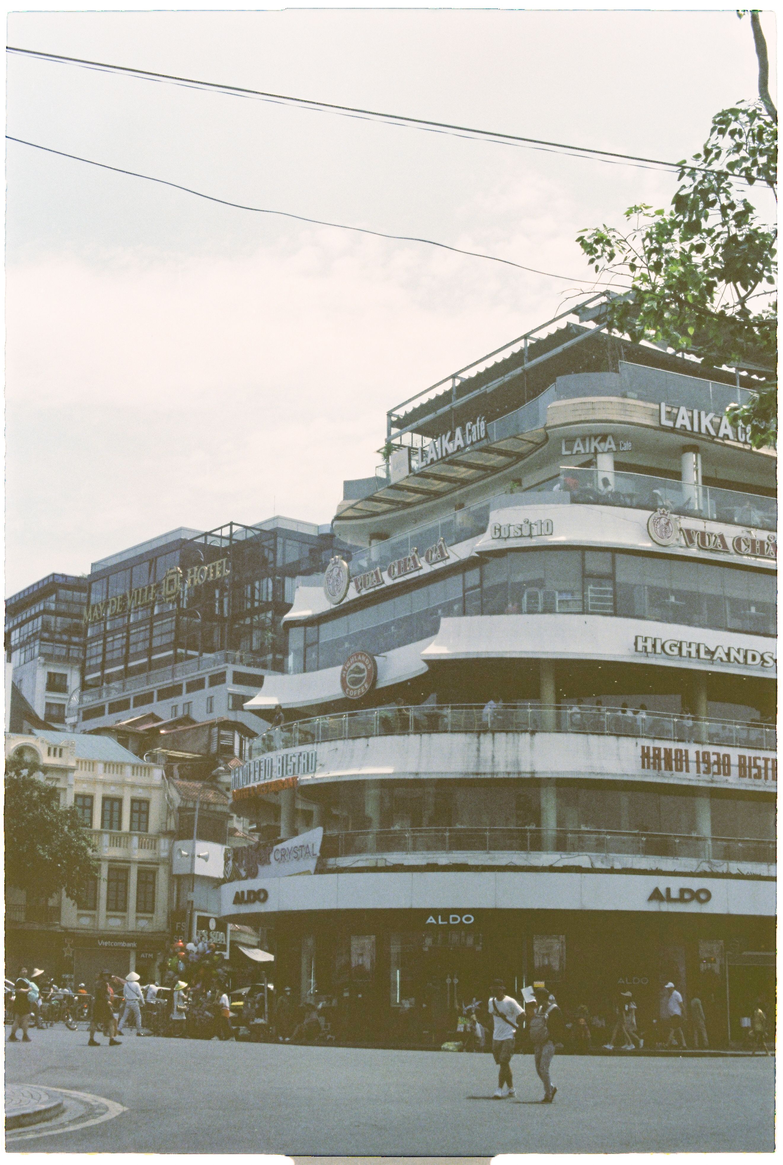 Urban street scene showcasing iconic architecture in Hanoi with bustling atmosphere.
